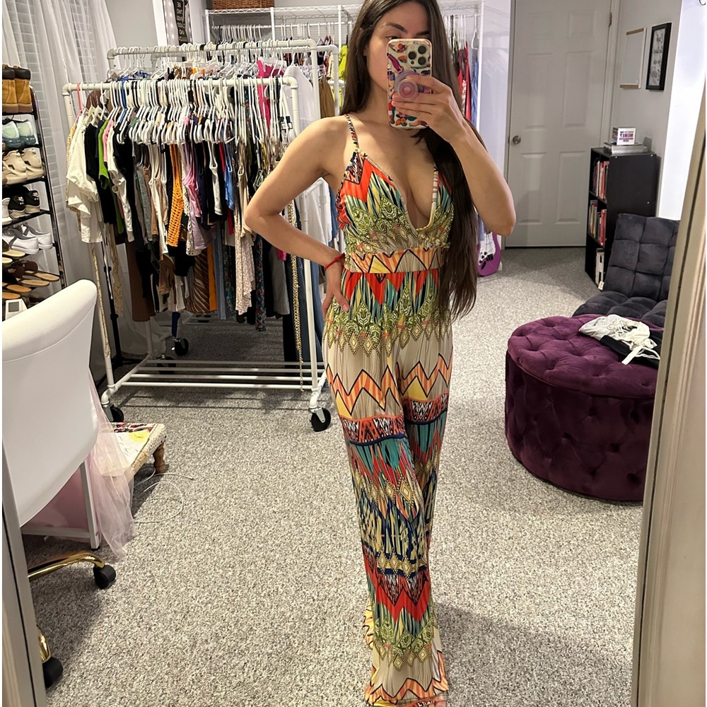 Multi color print Jumpsuit with low front drop. Crisscross back. Has stretch.